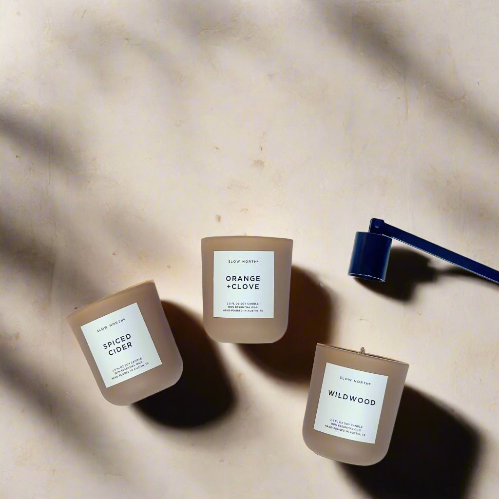 Three candles with labels on a white background