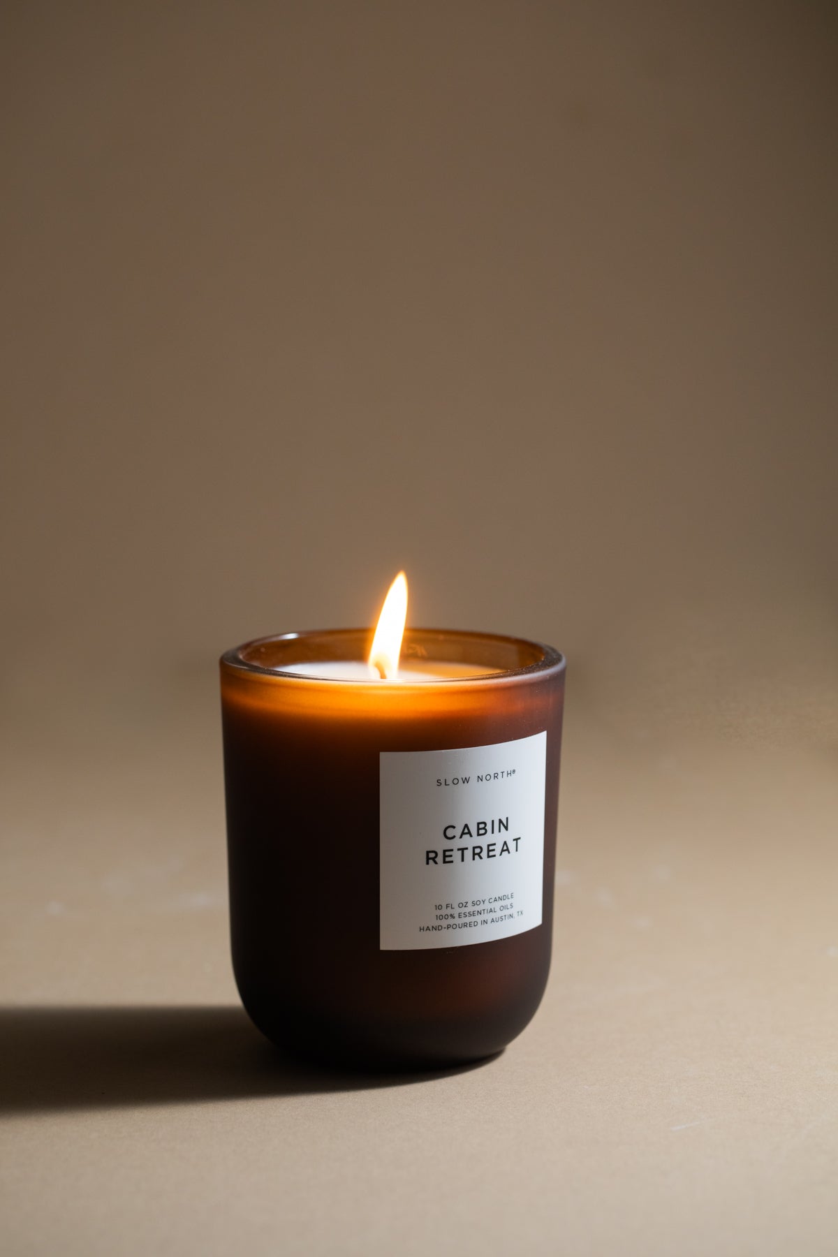 Candle labeled 'Cabin Retreat' on a beige background