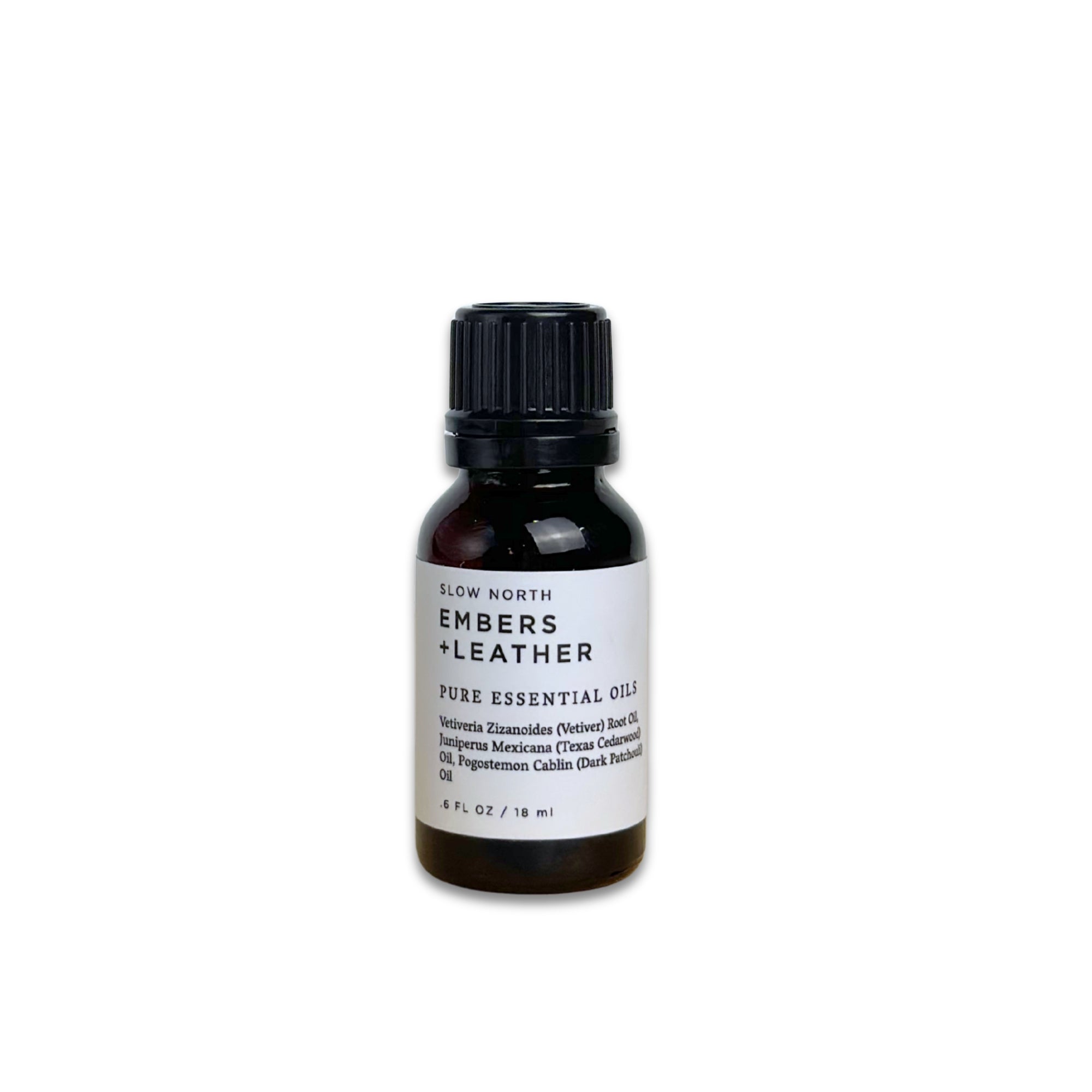 Bottle of 'Embers + Leather' pure essential oil on a white background