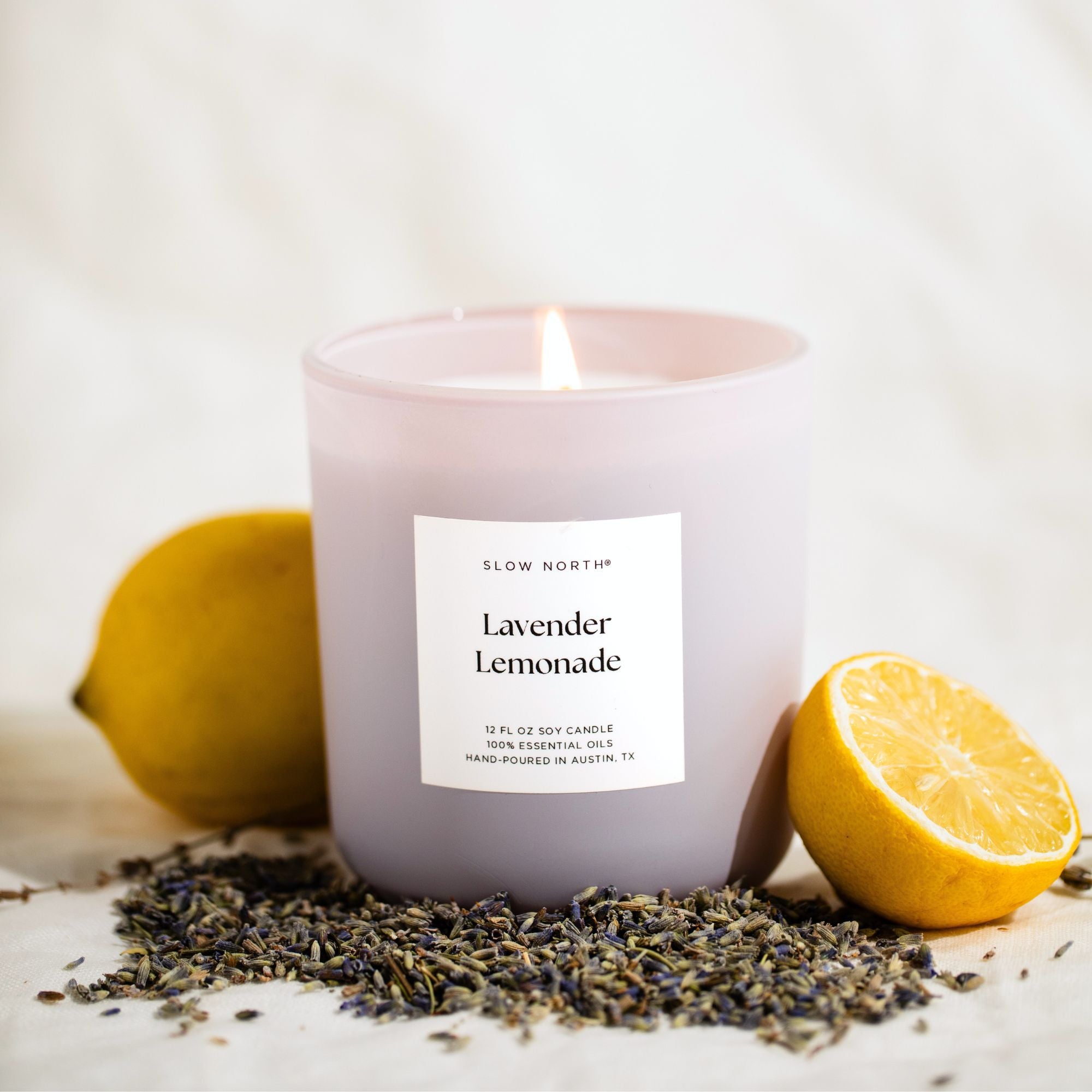 lavender lemonade candle with lemons and lavender buds on a light background