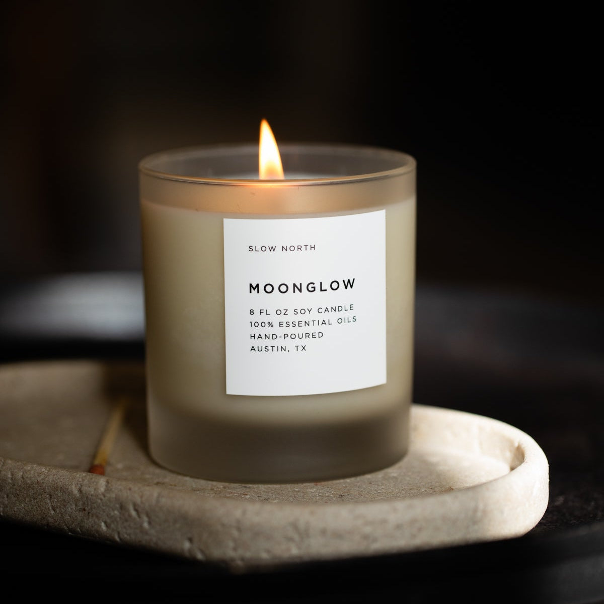 Candle labeled 'Hoonglow' on a dark background