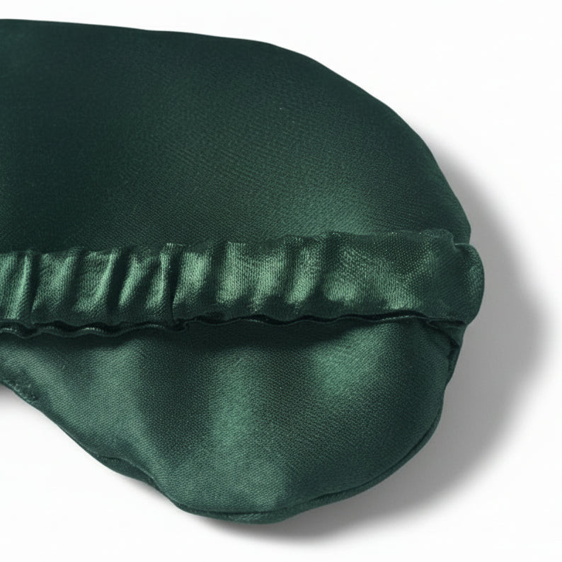 Green satin eye mask on a white background