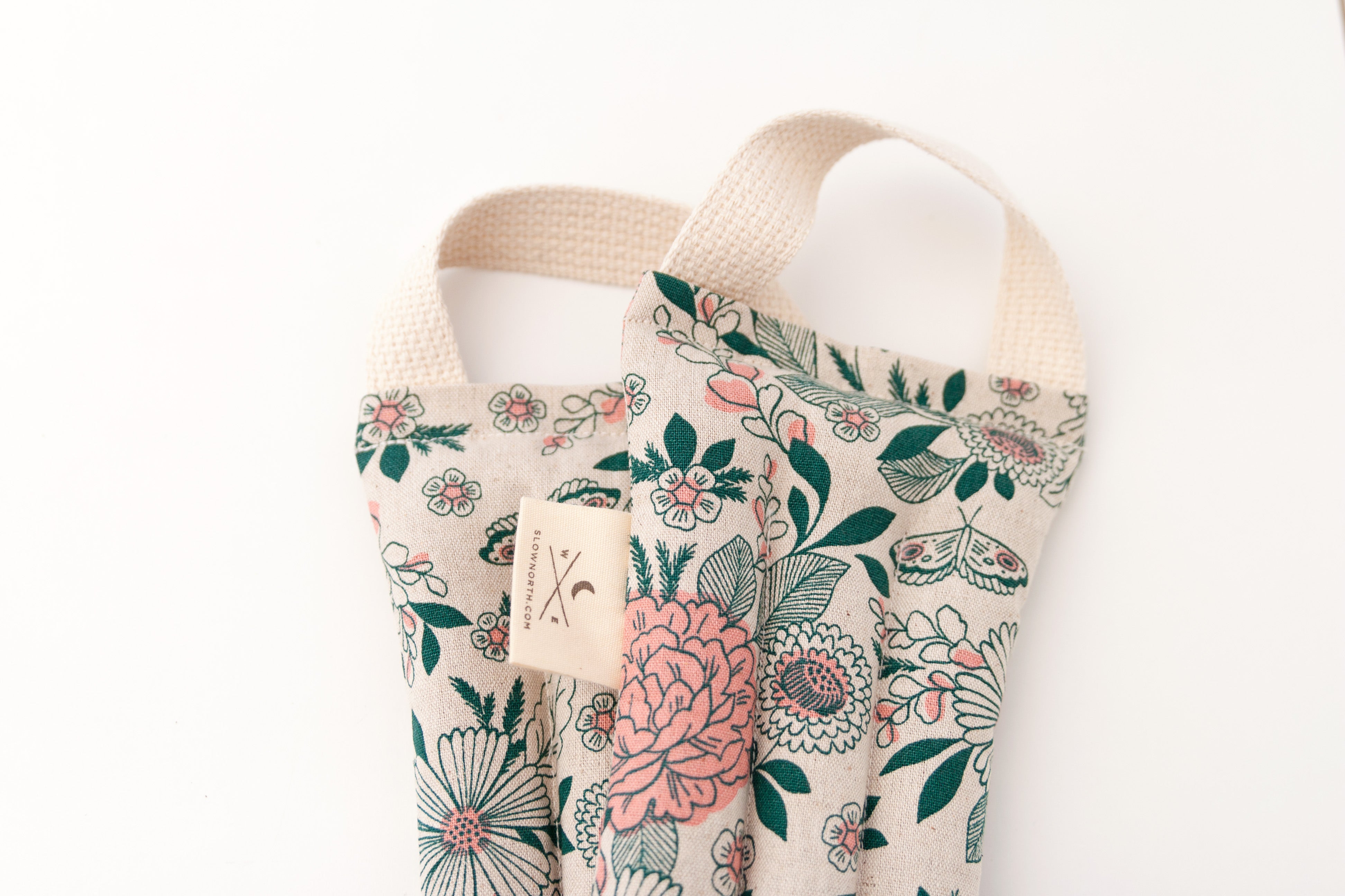 Pink and green floral pattern on cream fabric.