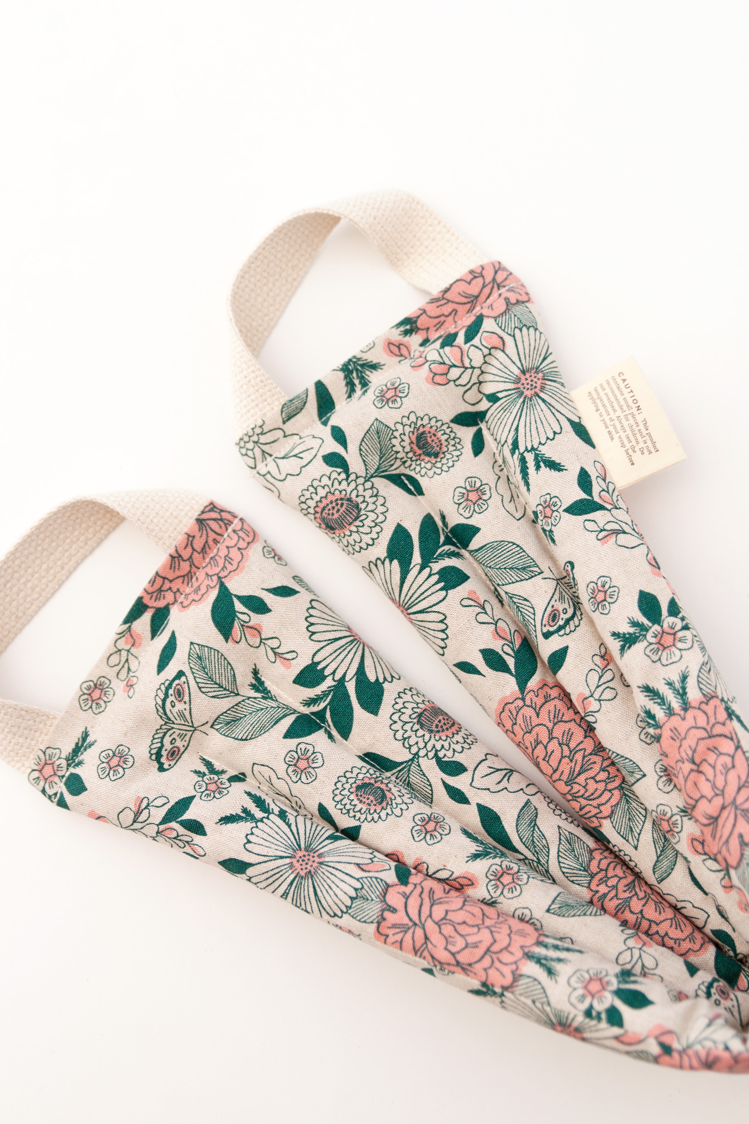 Pink and green floral pattern on cream fabric.