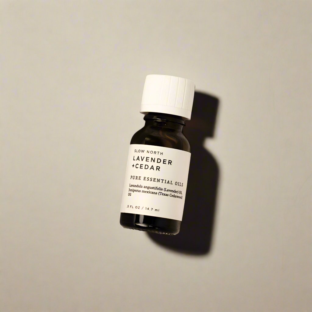 Lavender and cedar 100% pure essential oil blend from Slow North in an amber bottle.