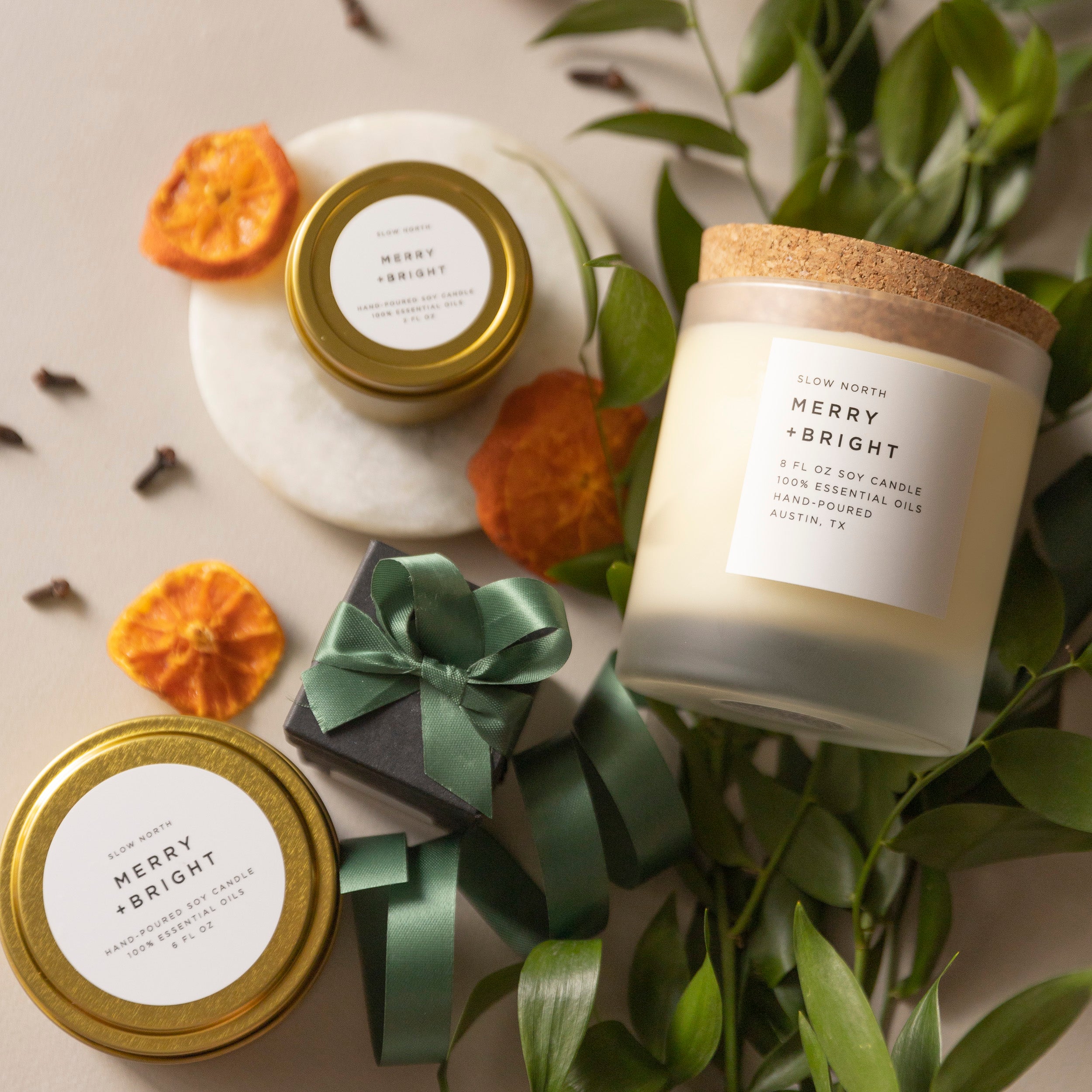 Slow North Merry and Bright candle and green and orange foliage