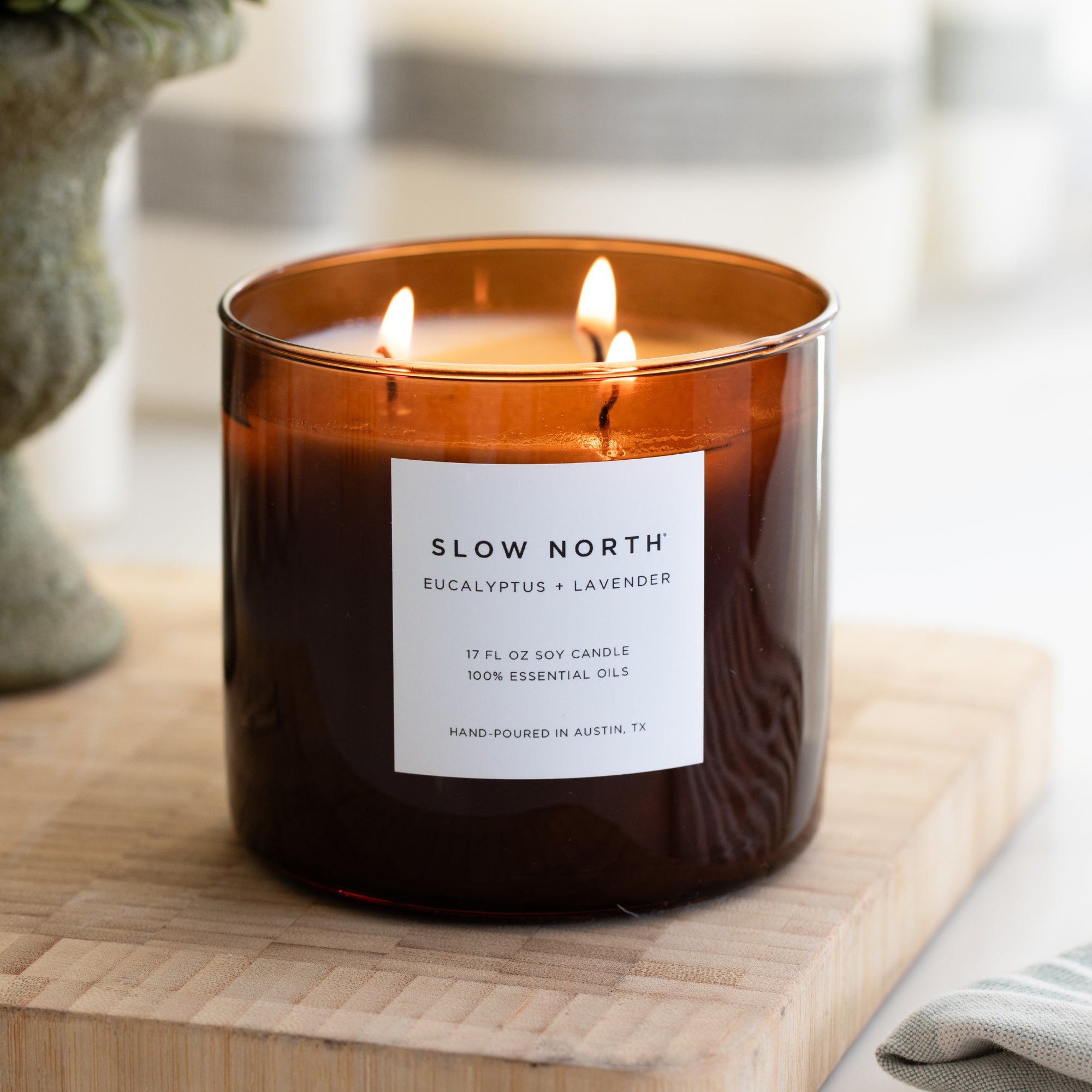large 3-wick natural candle sitting on a counter - spa scents