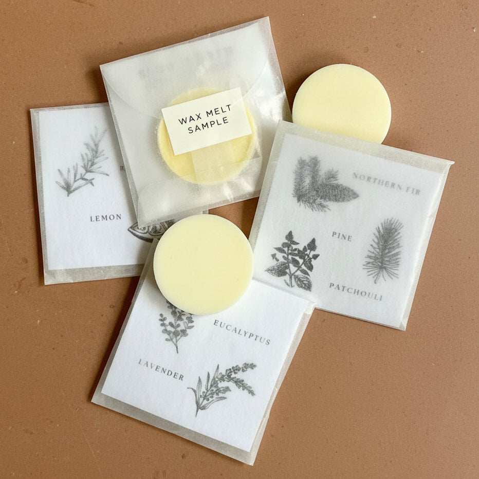 Wax melts in clear packaging with botanical labels on a white background