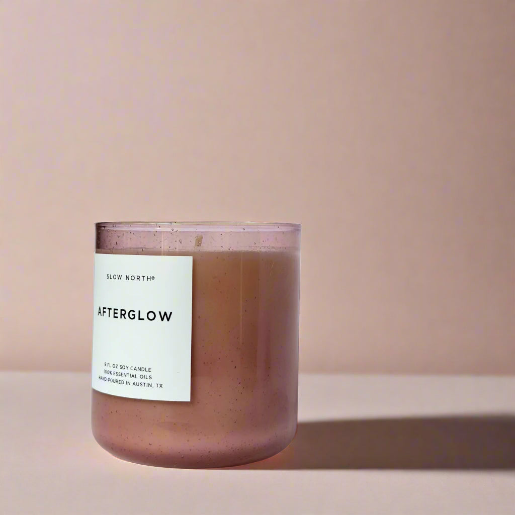 Pink candle labeled 'Afterglow' with a white label on a pink background