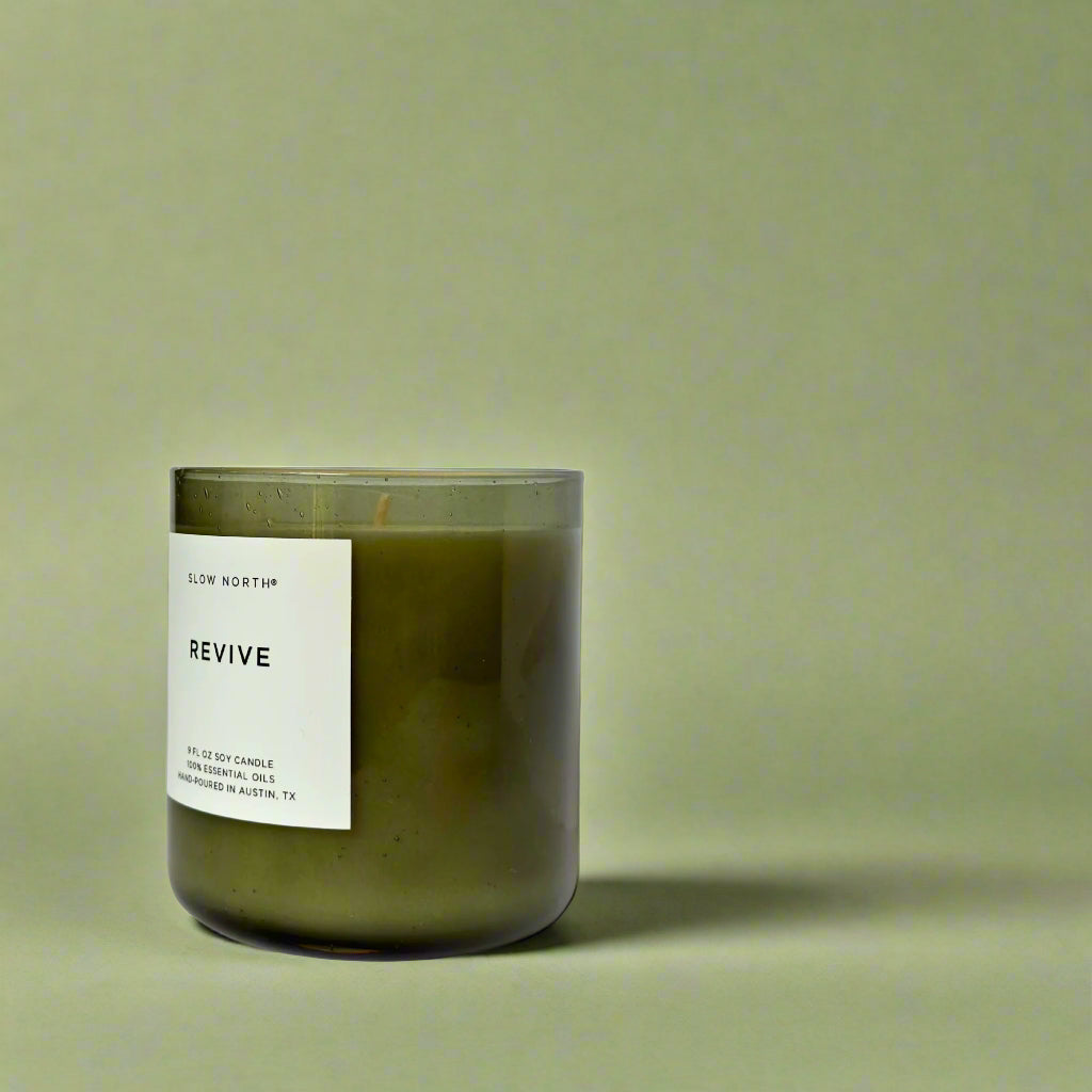 Green candle with a label on a green background