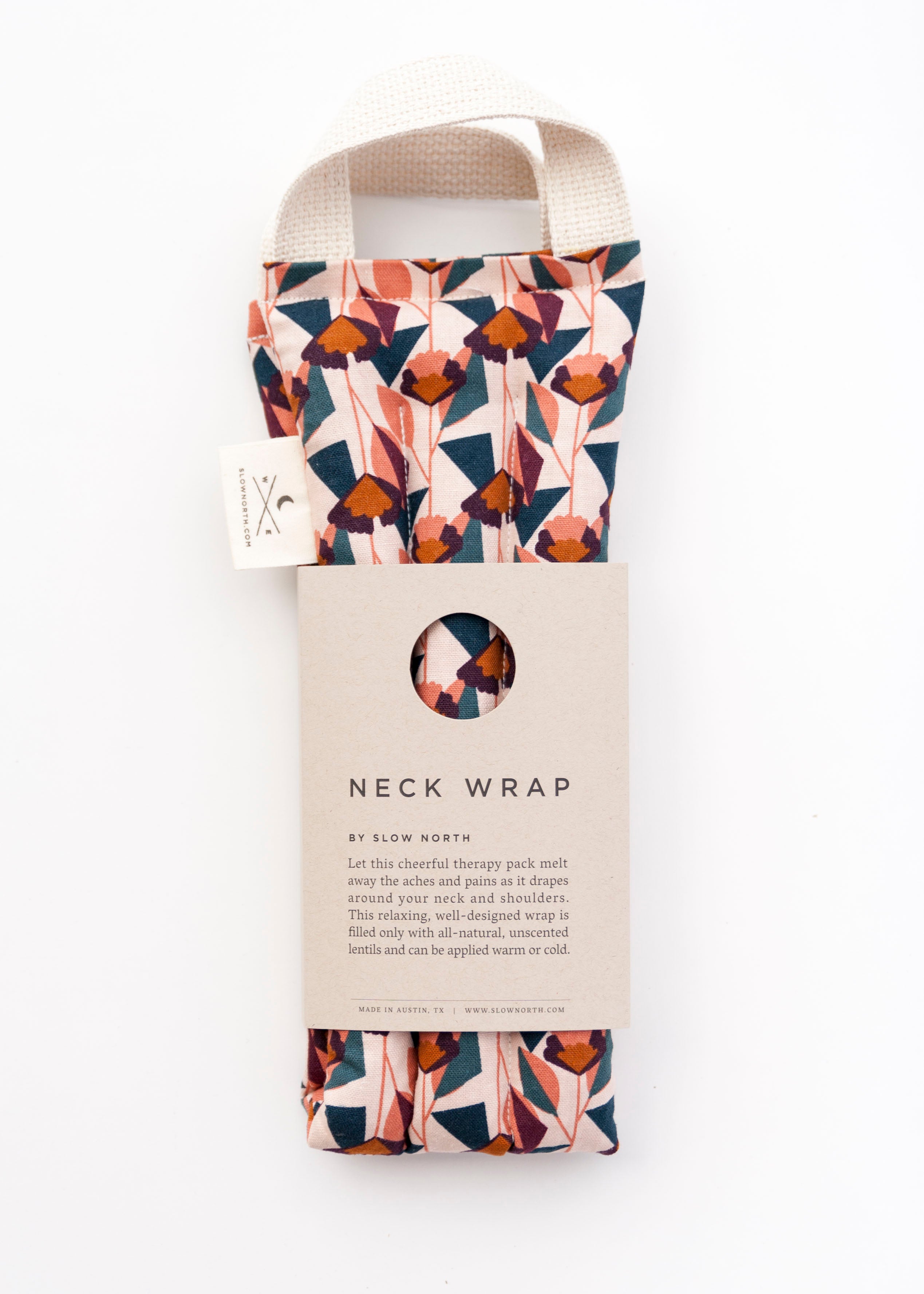 Colorful geometric fabric pattern of various pinks, cream, dark blue, dark orange.