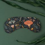 Eye mask with dark blue, green, yellow orange floral pattern made by Slow North