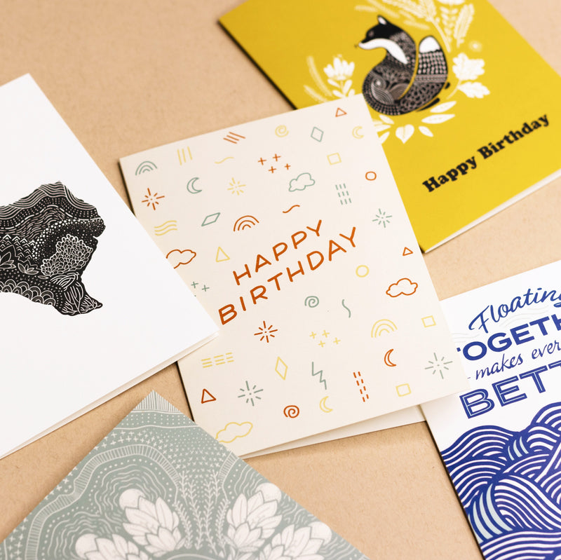 Various Slow North greeting cards on brown background. Happy Birthday Doodles Card by Slow North