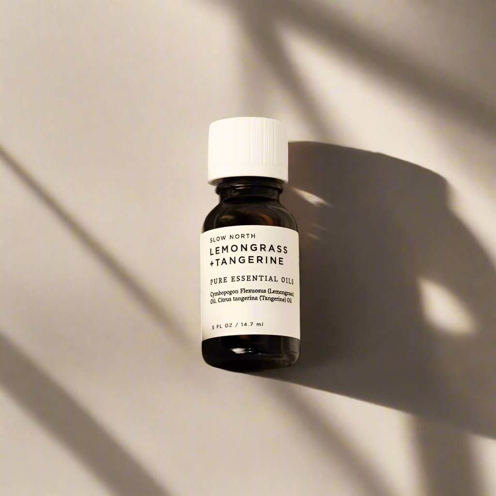 Lemongrass and Tangerine 100% pure essential oil blend from Slow North in an amber bottle.