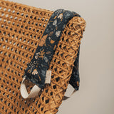 Neck Wrap - Canyon Springs pattern draped over wicker chair.