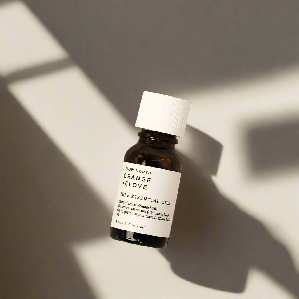 Orange and clove 100% pure essential oil blend from Slow North in an amber bottle.