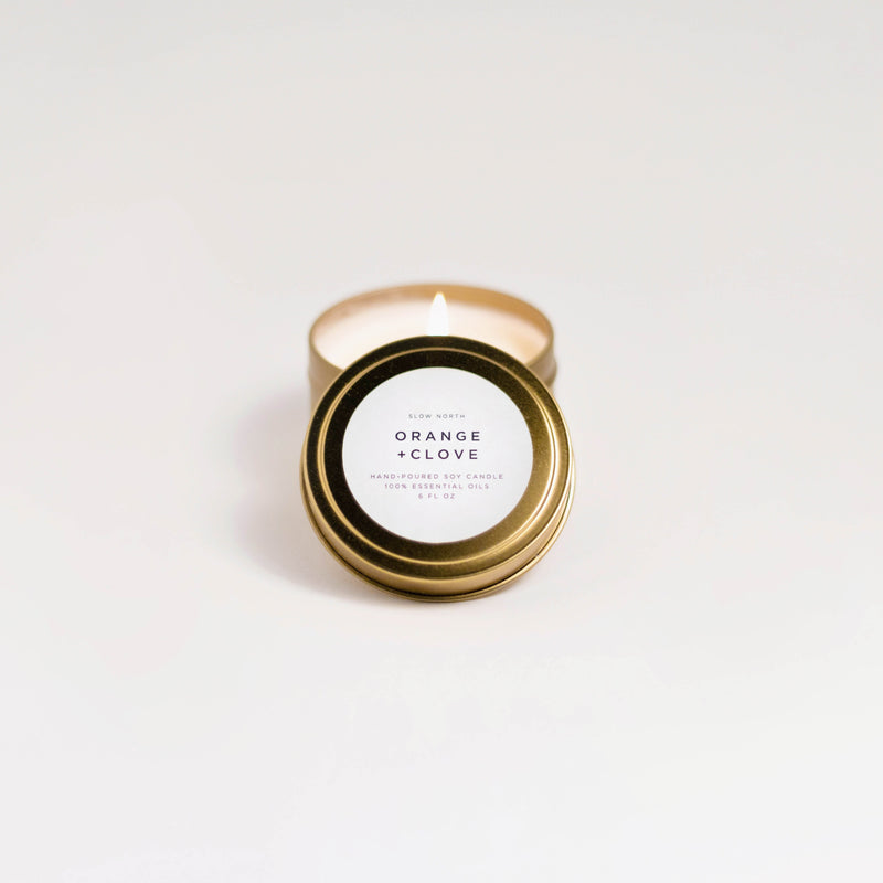 Orange + Clove soy wax candle in 6 ounce gold travel tin by Slow North