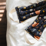Light pink, orange, and yellow floral pattern on dark blue fabric.